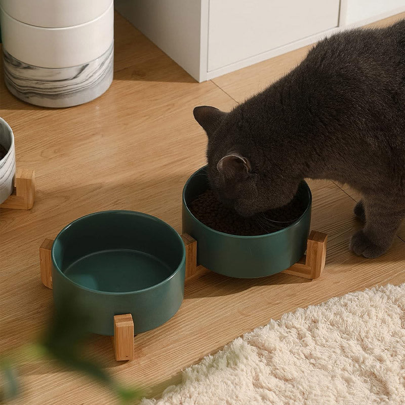 Double ceramic pet feeding bowls on an elevated wooden bamboo stand in stylish modern colors — view 5
