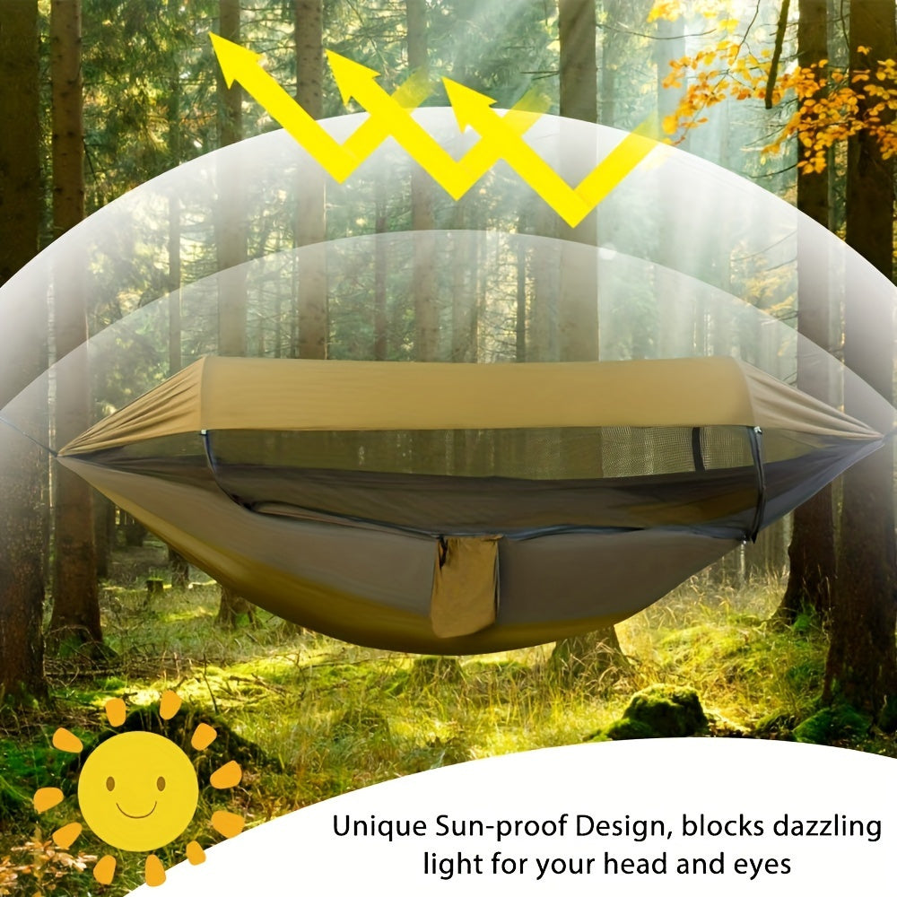 Green nylon double camping hammock with mosquito net hanging between two trees in a forest — view 4