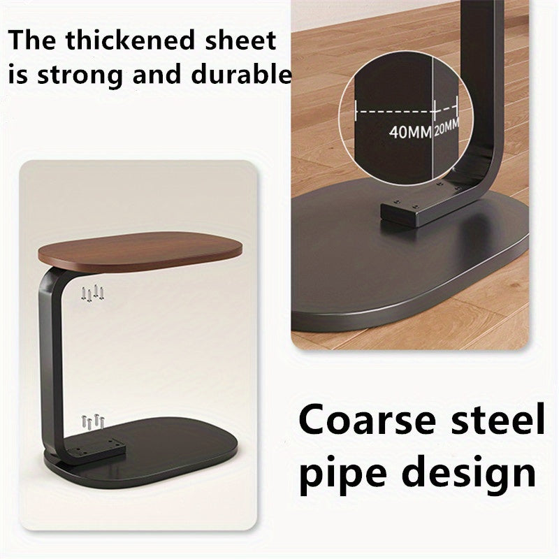Nut-brown C-shaped side table with sleek metal frame in a modern living room setting. — view 2