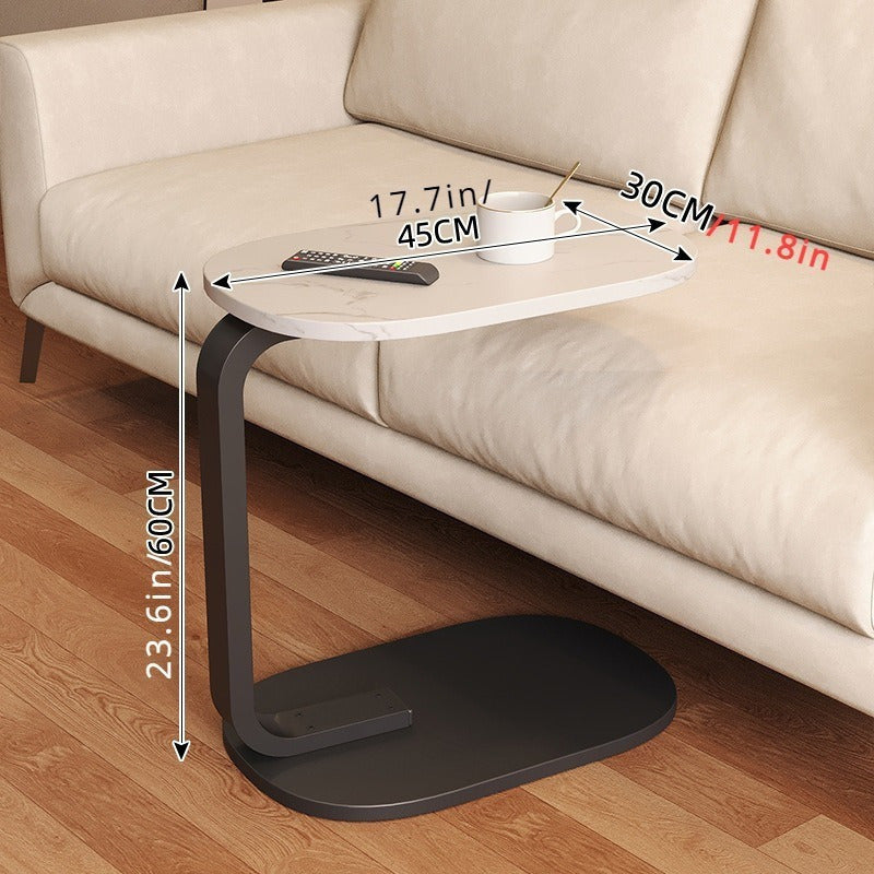 Nut-brown C-shaped side table with sleek metal frame in a modern living room setting. — view 4