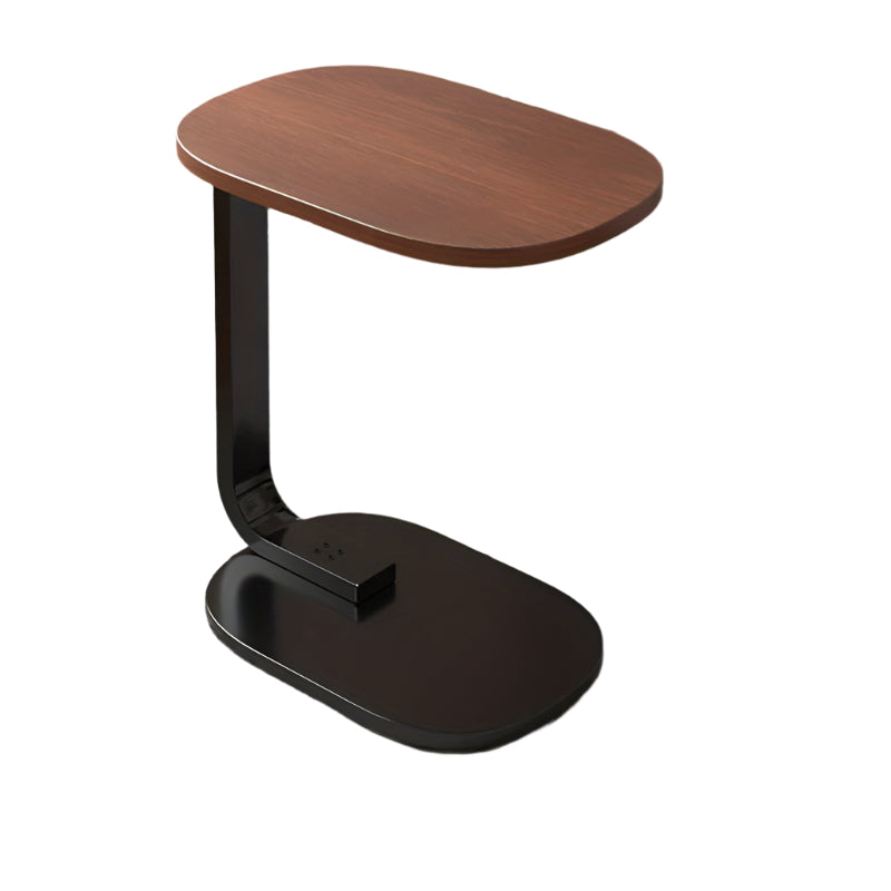 Nut-brown C-shaped side table with sleek metal frame in a modern living room setting.