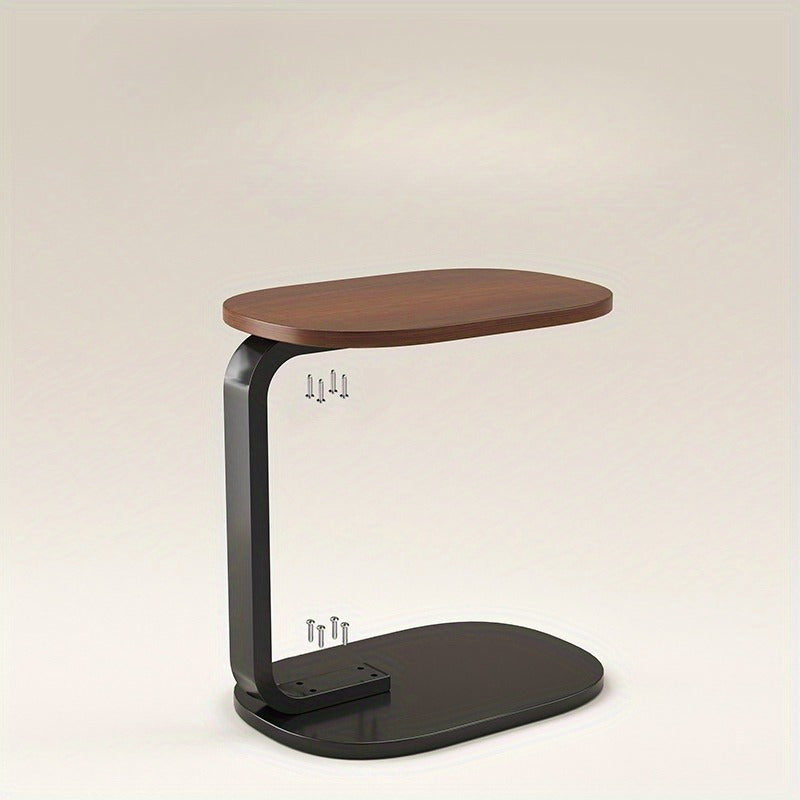 Nut-brown C-shaped side table with sleek metal frame in a modern living room setting. — view 3