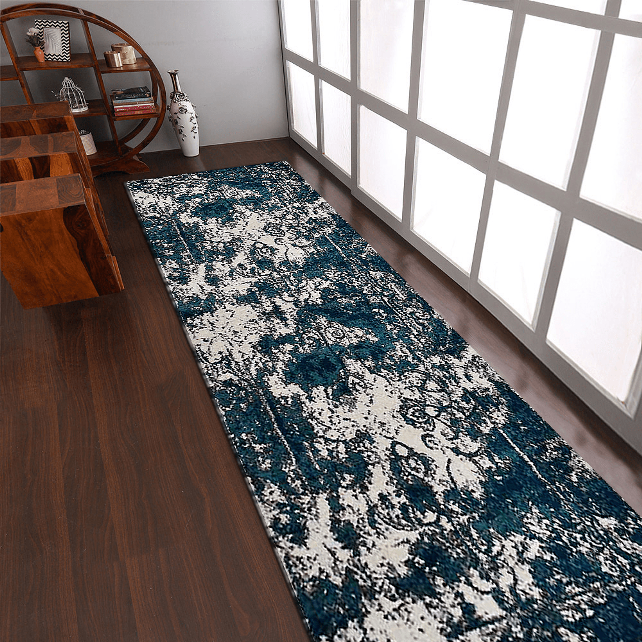 Abstract ivory and blue machine woven runner rug rolled out in a modern hallway setting — view 4