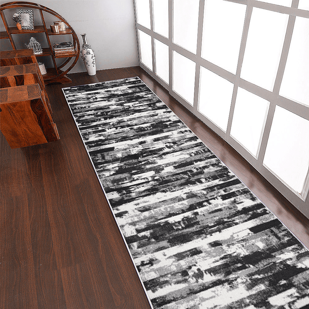 Abstract ivory and blue machine woven runner rug rolled out in a modern hallway setting — view 5