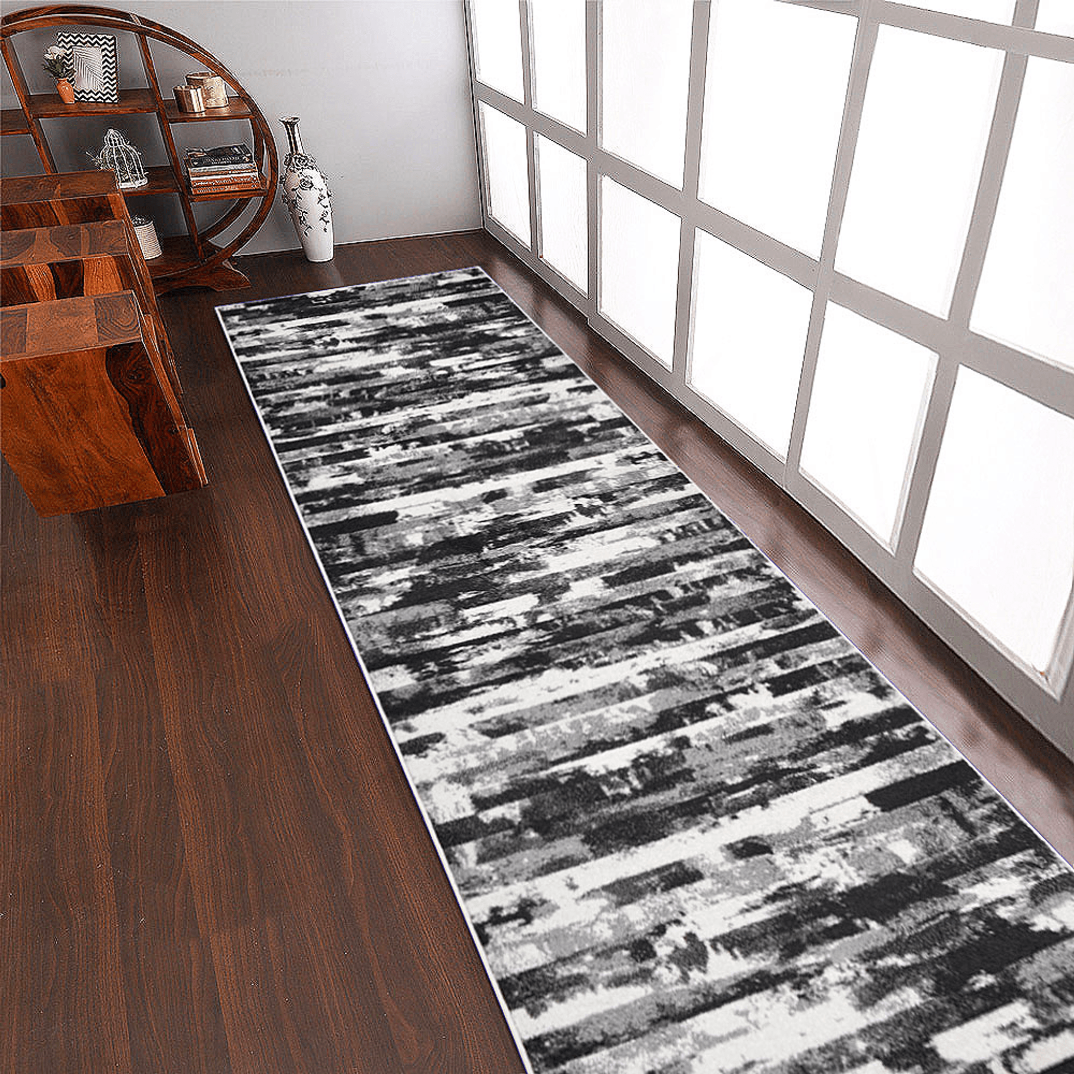 Abstract ivory and blue machine woven runner rug rolled out in a modern hallway setting — view 5