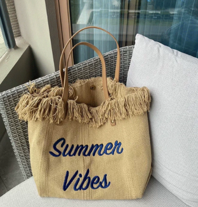 Large woven canvas tote bag for women featuring embroidered letters and sturdy shoulder carry straps — view 2