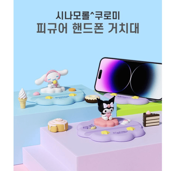 Cute Sanrio character desktop phone stand cradle featuring Kuromi and Cinnamoroll holding a smartphone securely — view 2