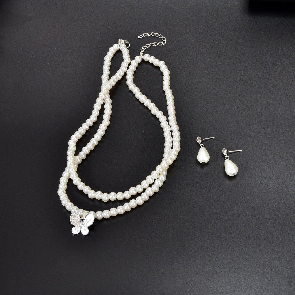 Imitation pearl jewelry set featuring a double layered necklace and matching water drop earrings — view 3