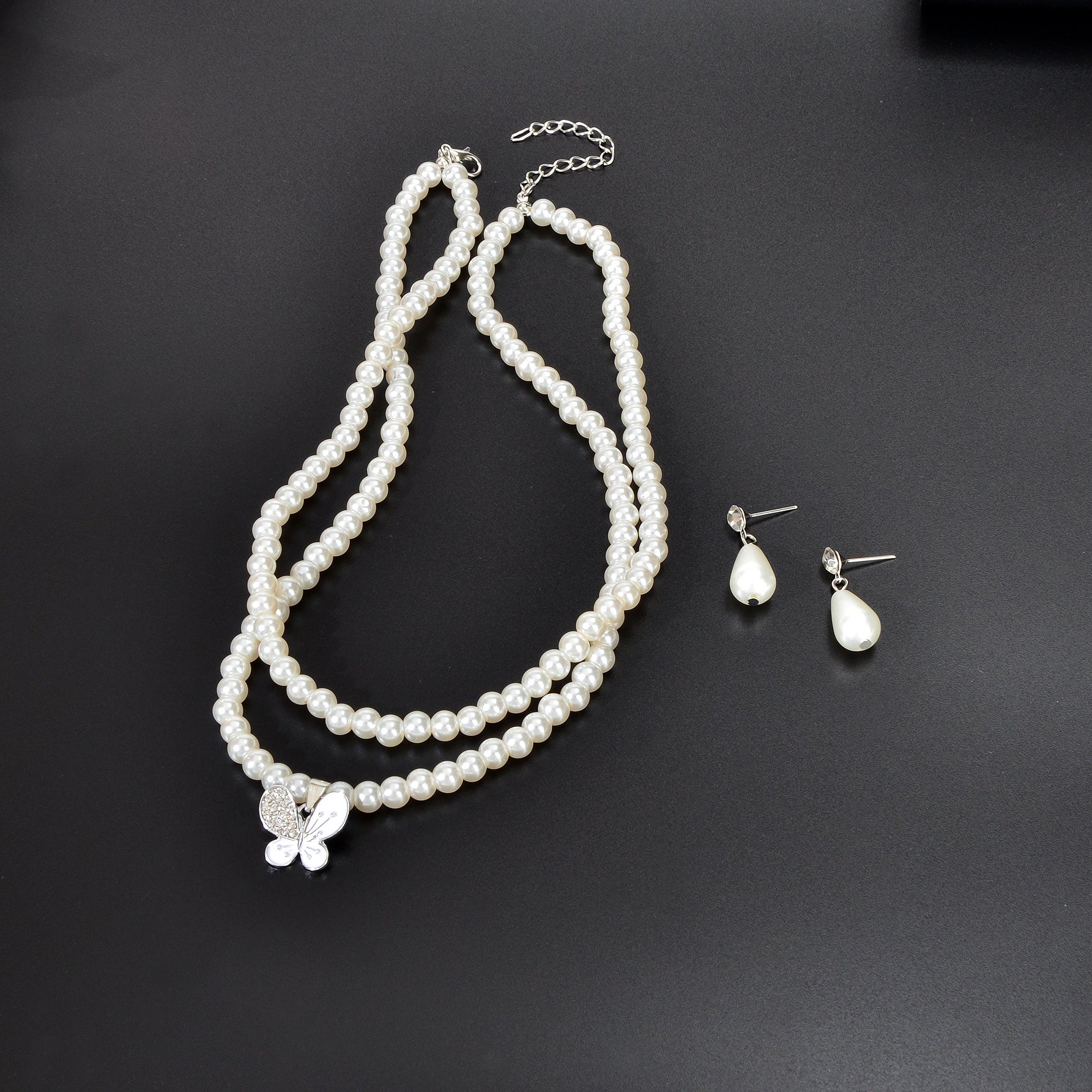 Imitation pearl jewelry set featuring a double layered necklace and matching water drop earrings — view 3