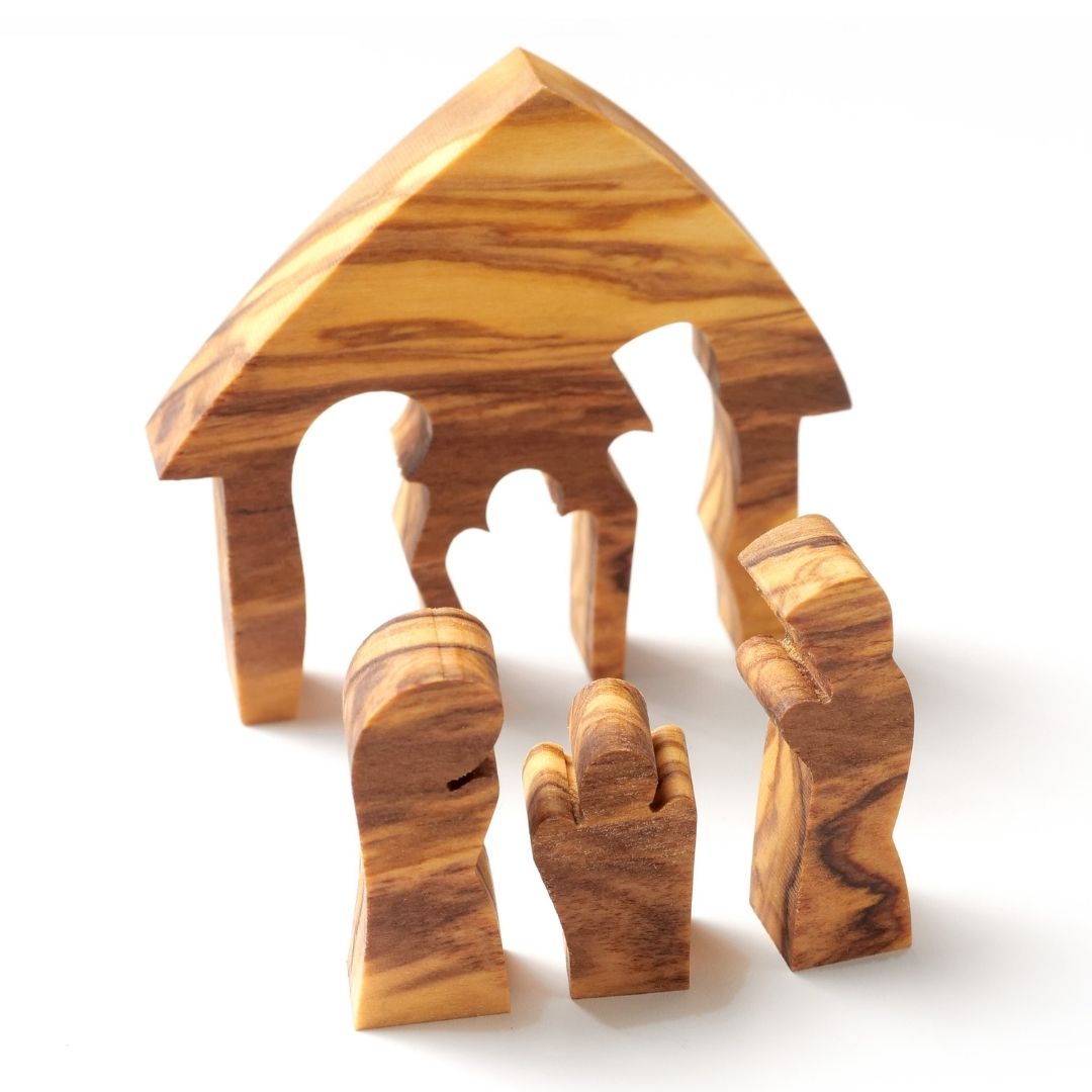 Olive wood nativity scene puzzle with carved figures of Mary, Joseph, and baby Jesus.
