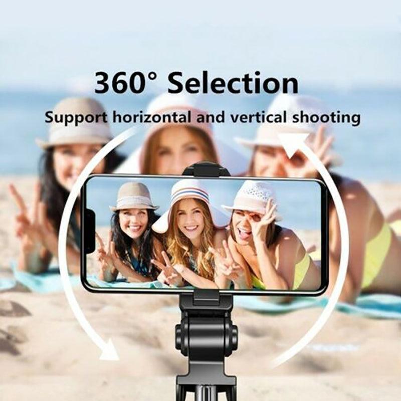 Wireless Bluetooth selfie stick tripod fully extended with smartphone mount and remote control attached — view 3