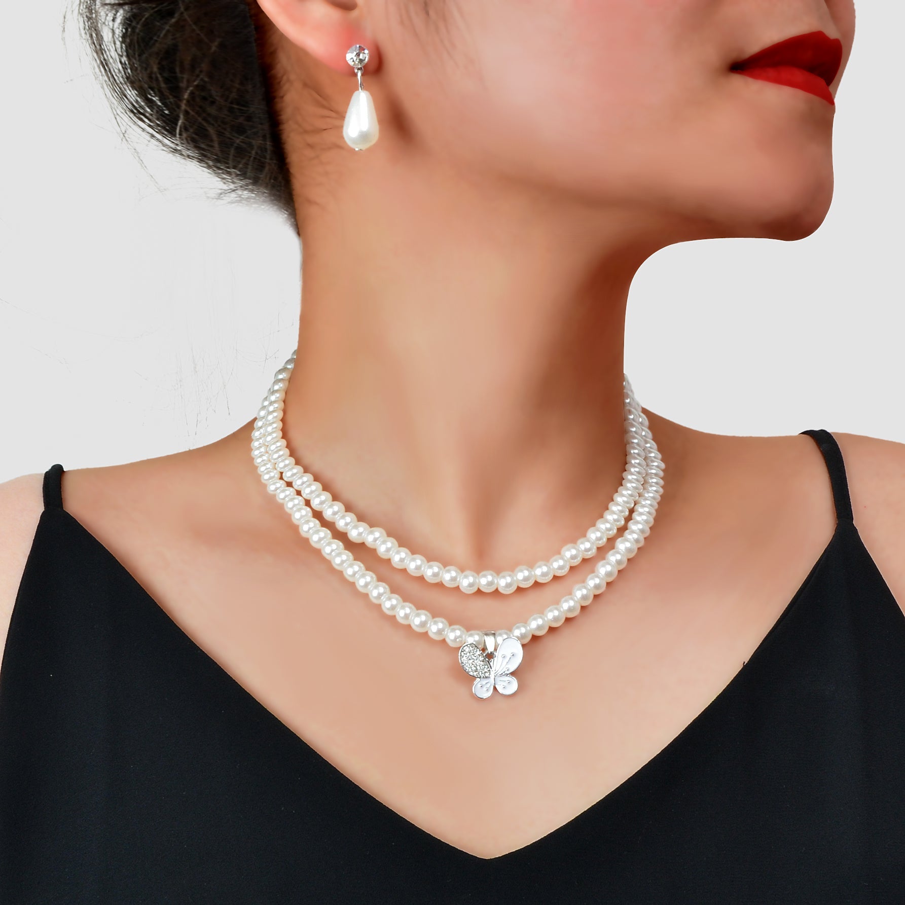 Imitation pearl jewelry set featuring a double layered necklace and matching water drop earrings