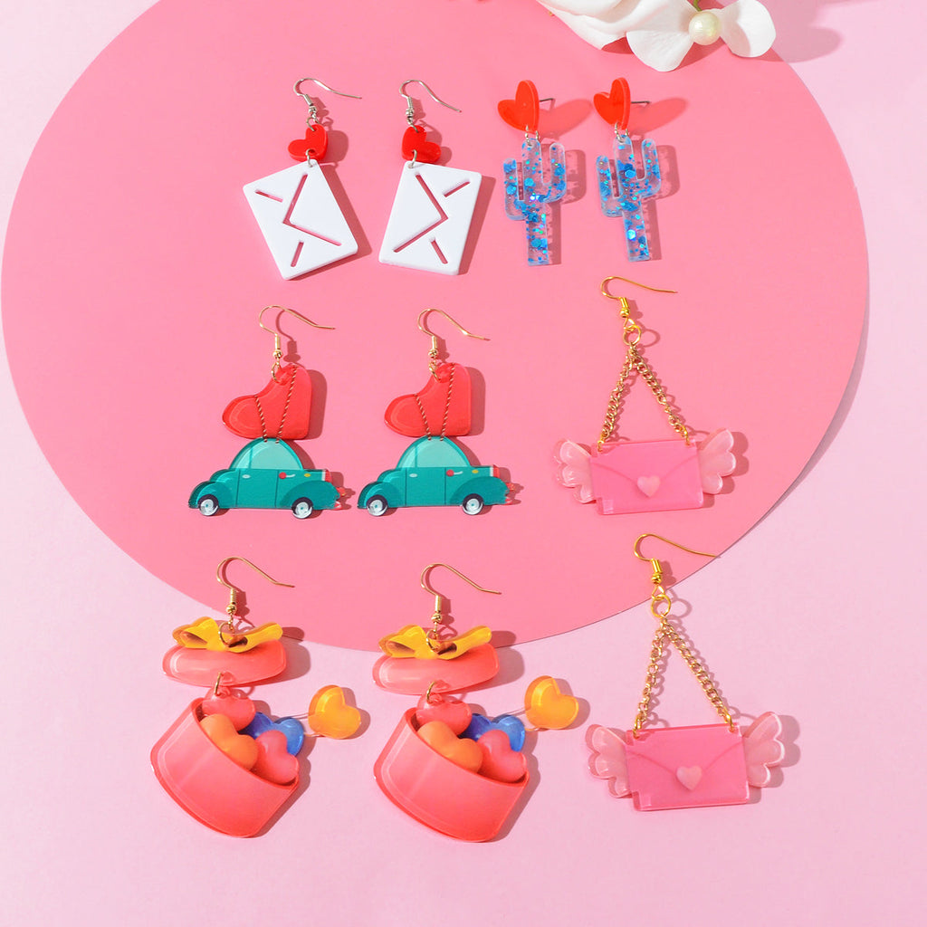 Pink sweetheart pendant dangle earrings with metal alloy hooks on a clean background