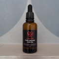 Pure organic hair oil in a 50mL amber glass bottle with a minimalist label