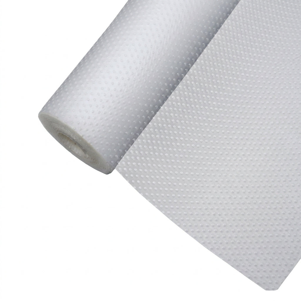 Transparent EVA cabinet shelf liner mat roll unrolled on a wooden kitchen drawer surface