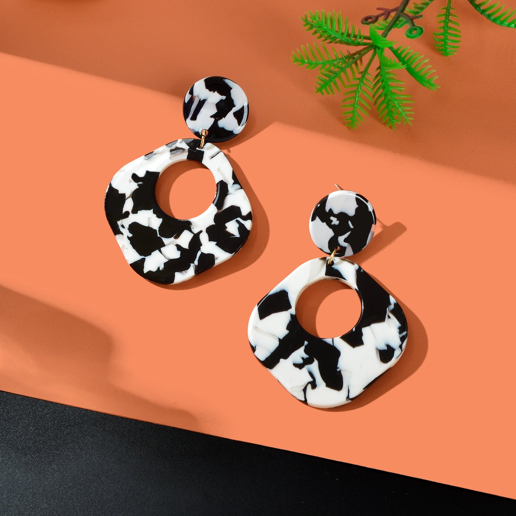 Retro black and white acrylic tortoise shell dangle earrings with round and square geometric design — view 2