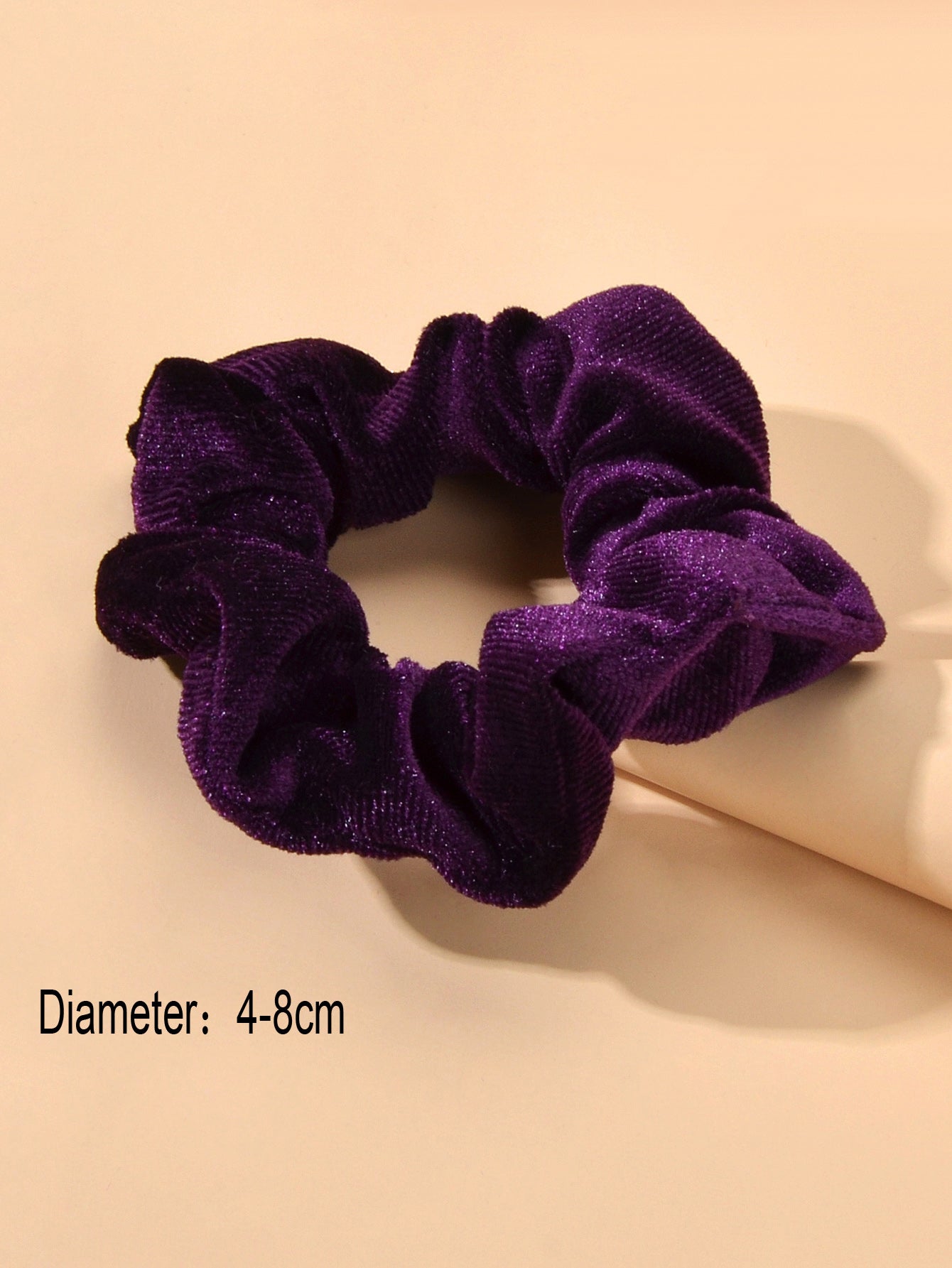 Retro velvet elastic scrunchie hair tie displaying soft fabric texture and flexible circular shape — view 4