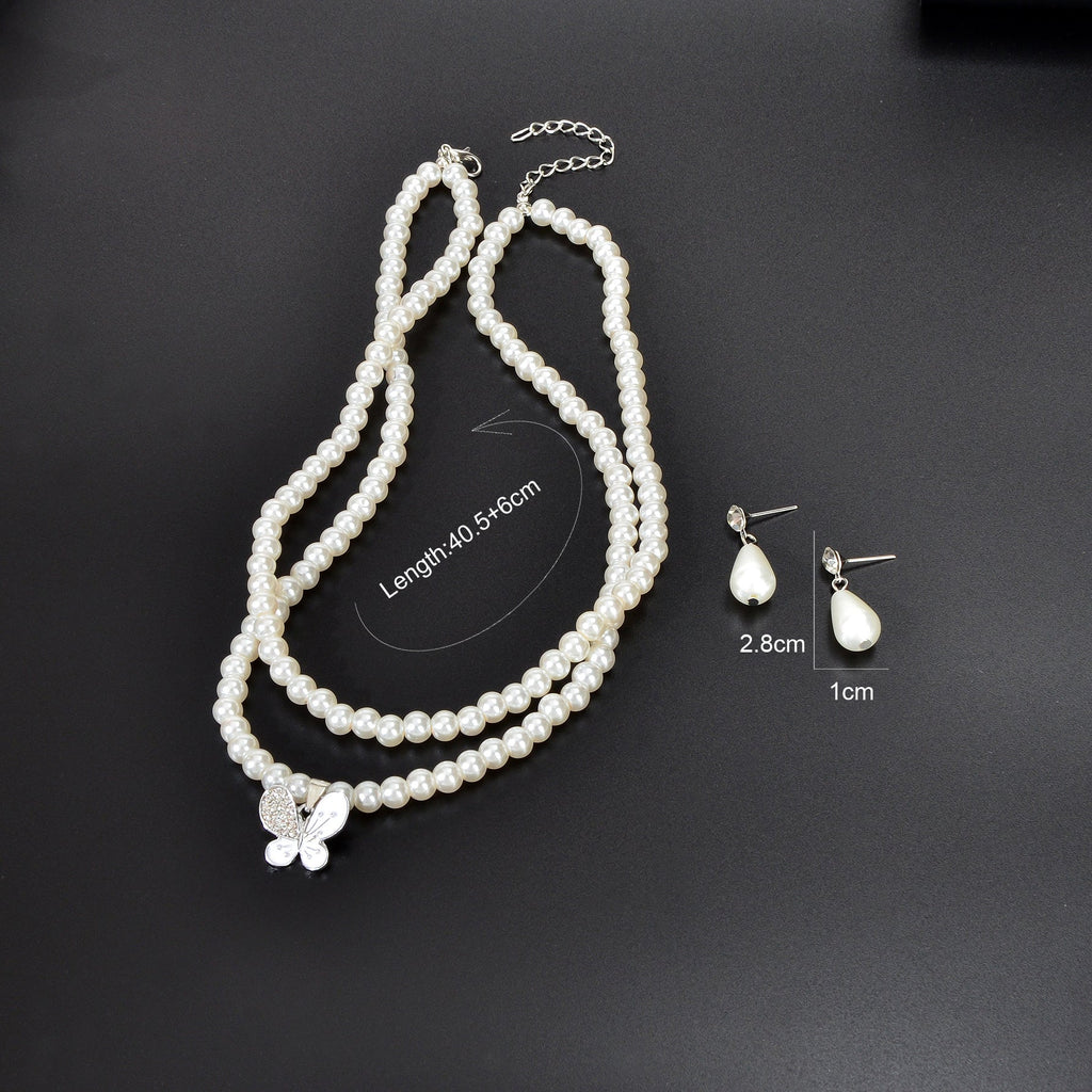 Imitation pearl jewelry set featuring a double layered necklace and matching water drop earrings — view 4