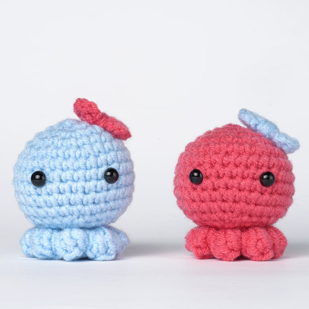 Octopus amigurumi DIY crochet kit with vibrant threads, hook, fiberfill, and detailed instructions.