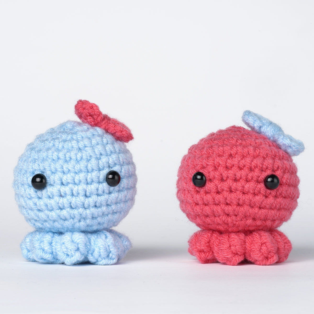 Octopus amigurumi DIY crochet kit with vibrant threads, hook, fiberfill, and detailed instructions.