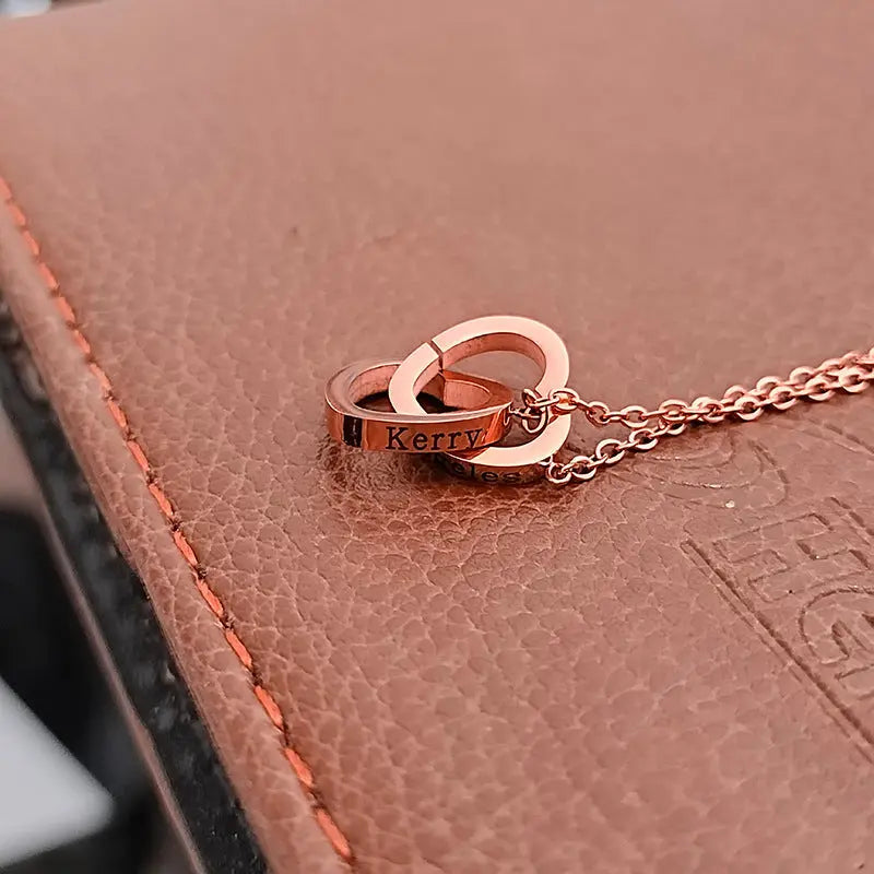 Double heart name necklace in stainless steel featuring interlocking customizable pendants on a delicate chain. — view 5