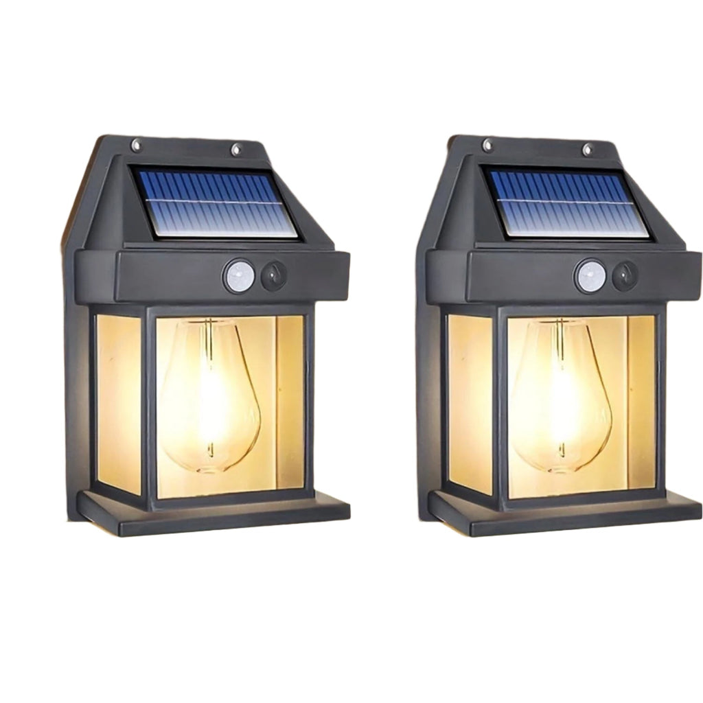 Two black plastic solar motion sensor LED outdoor security lights mounted on a wall