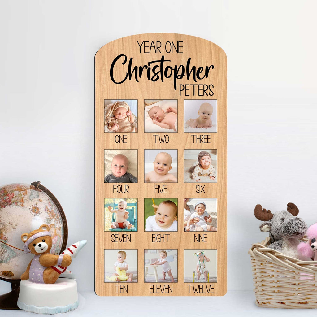 Custom wooden baby milestone photo board displaying twelve months of pictures with personalized cut out name — view 2