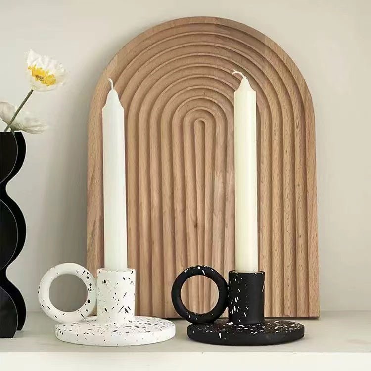 Two trendy splash-ink resin candle holders featuring a modern Nordic design on a flat surface
