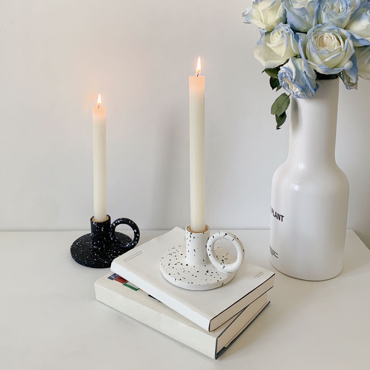 Two trendy splash-ink resin candle holders featuring a modern Nordic design on a flat surface — view 3