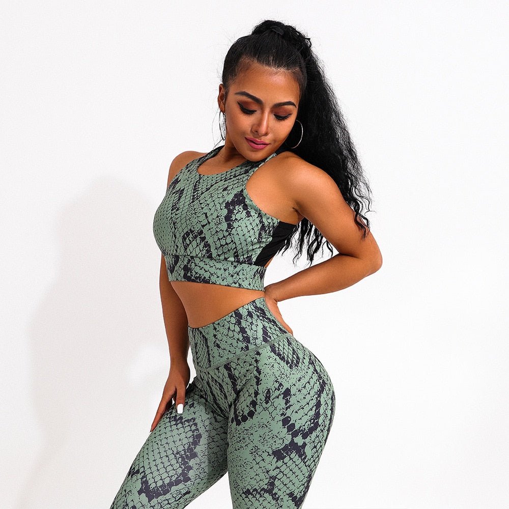 Two-piece snake print yoga set with green sleeveless sports bra and matching high-waisted fitness leggings