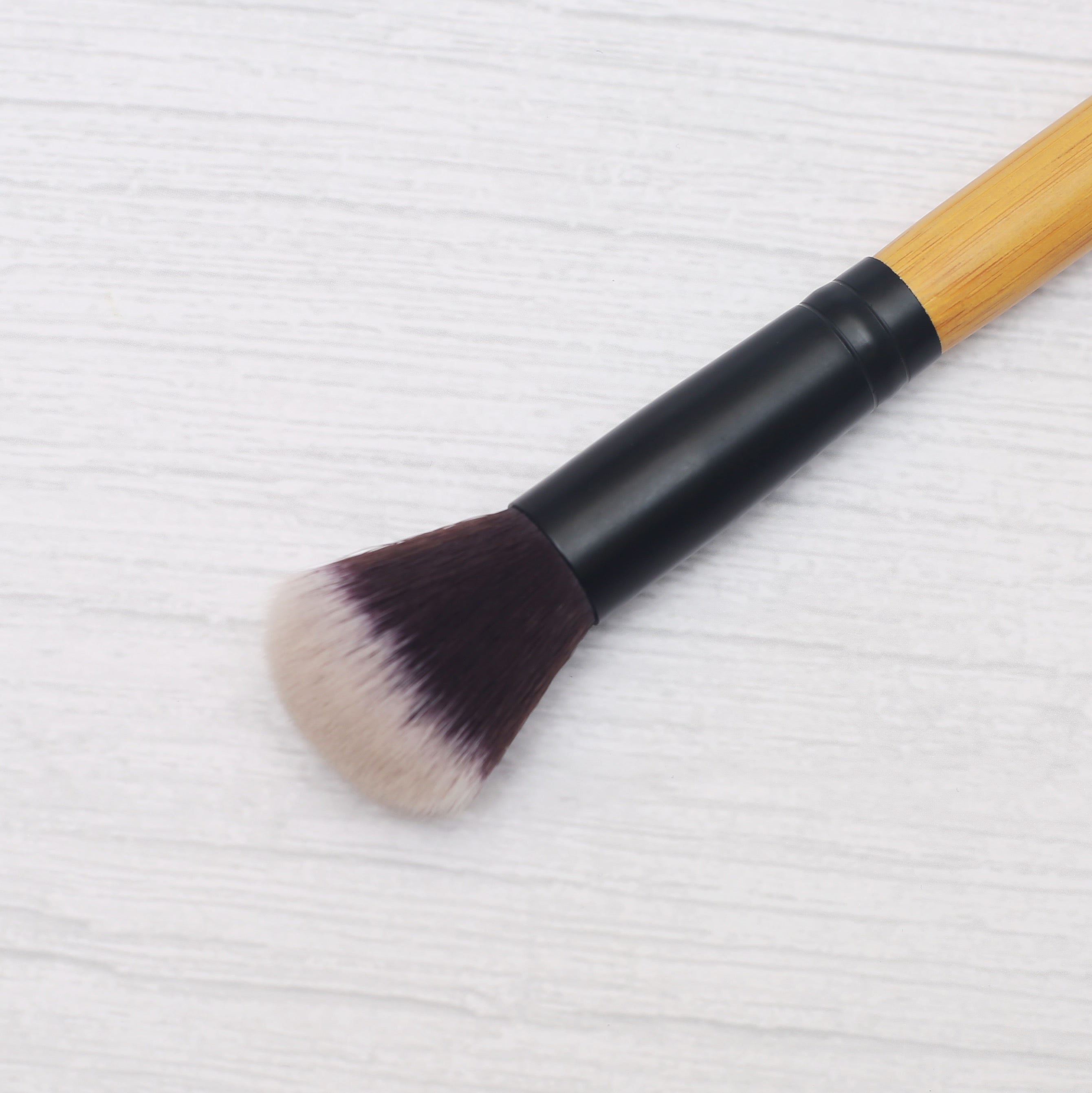 Vegan highlighter brush with natural bamboo handle and soft synthetic bristles for precision makeup — view 2