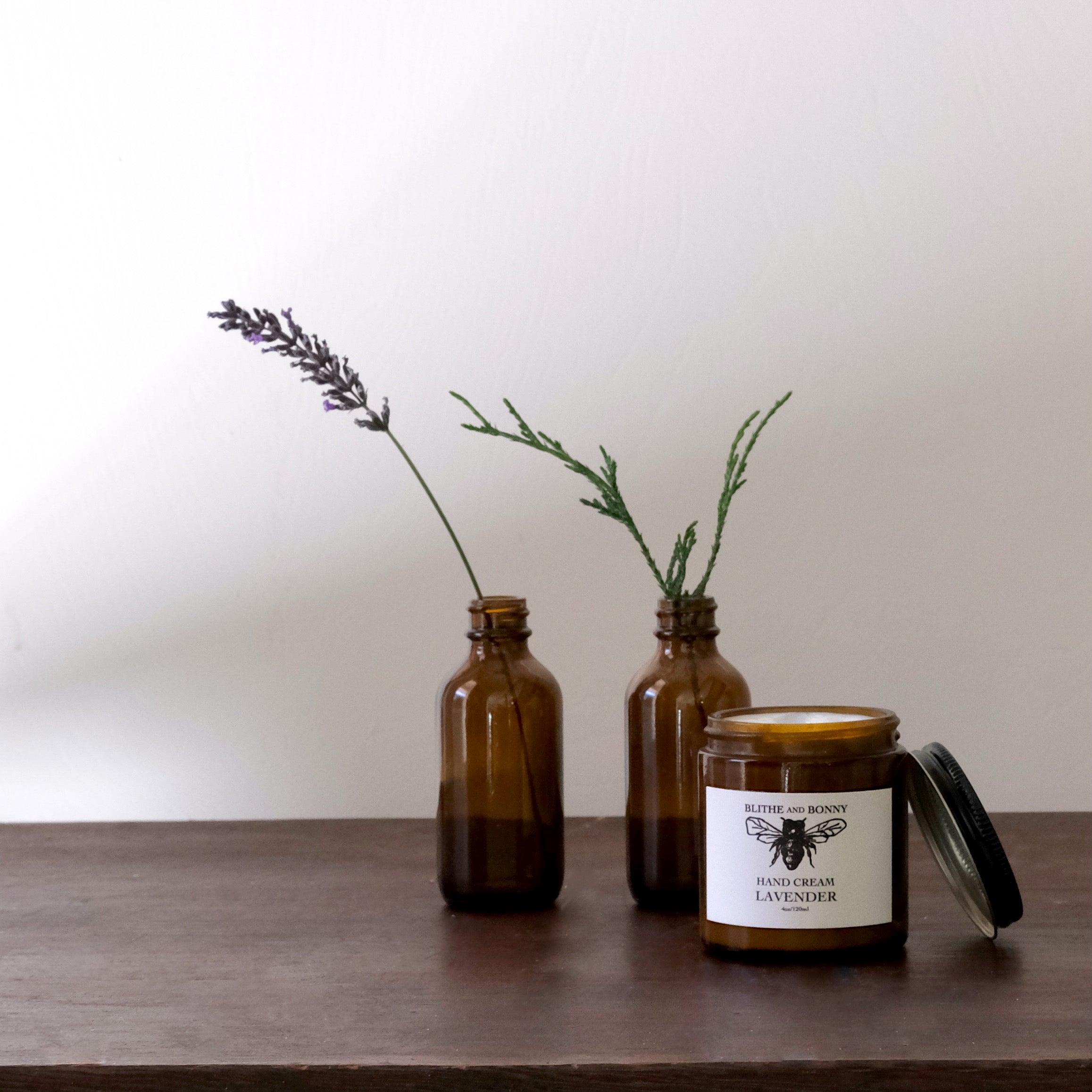 Luxurious vegan hand cream in a four ounce amber glass jar with a metal lid — view 4