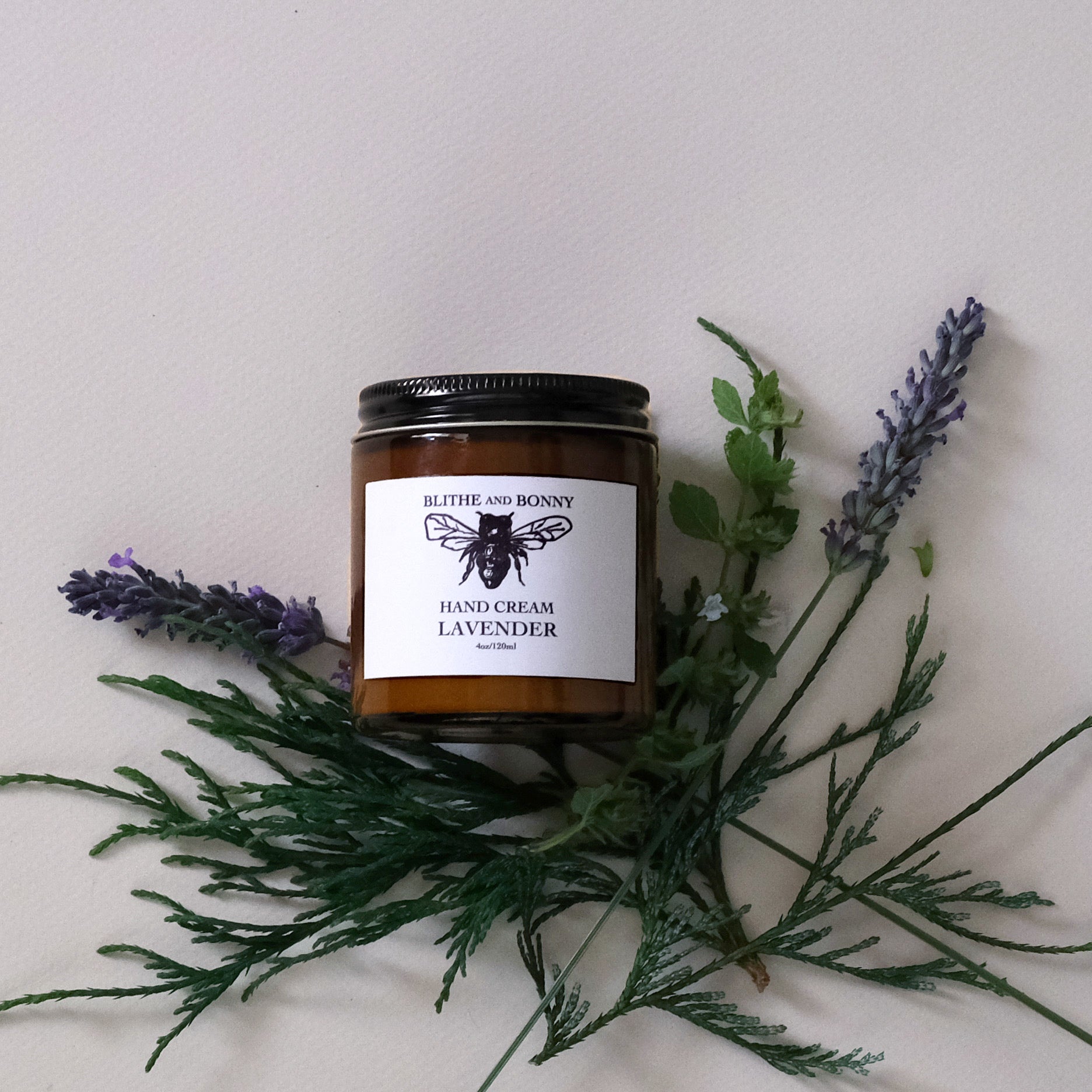 Luxurious vegan hand cream in a four ounce amber glass jar with a metal lid — view 3