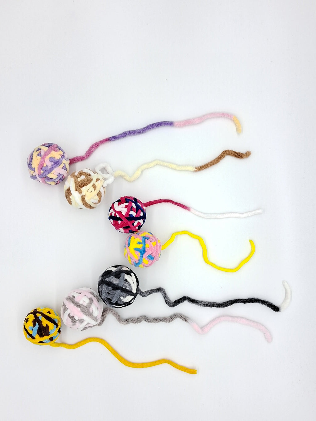 Large textured yarn ball cat toy in assorted colors with an interactive attached string tail — view 3