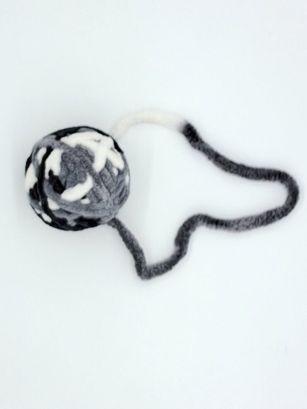 Large textured yarn ball cat toy in assorted colors with an interactive attached string tail — view 4