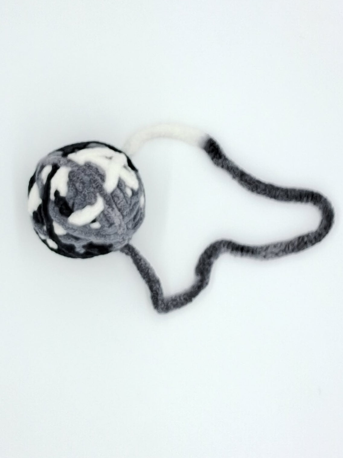 Large textured yarn ball cat toy in assorted colors with an interactive attached string tail — view 4