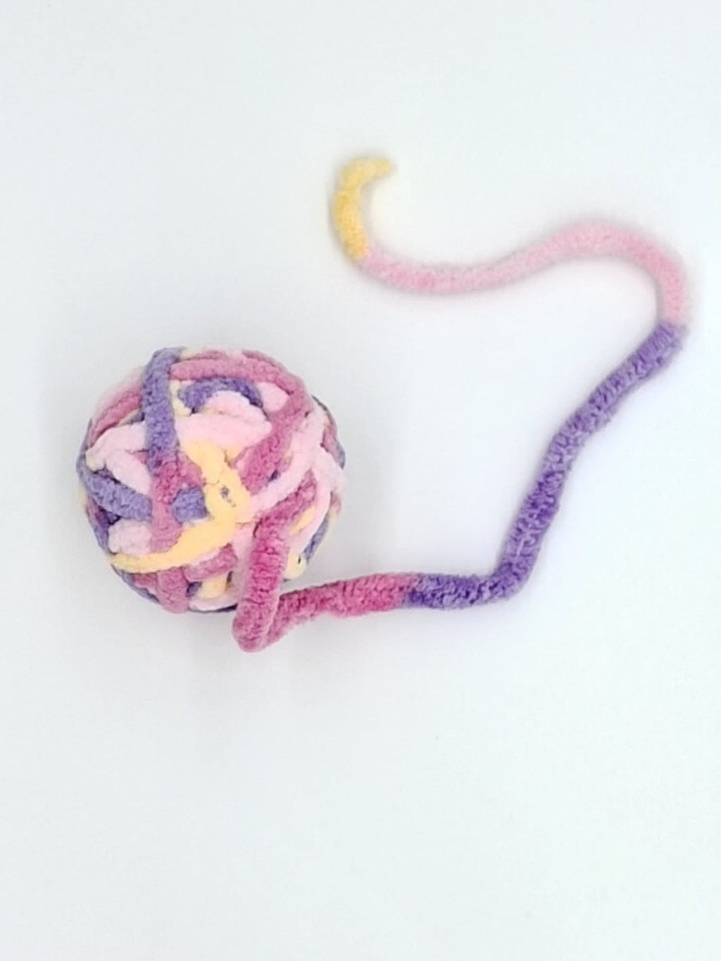 Large textured yarn ball cat toy in assorted colors with an interactive attached string tail — view 5