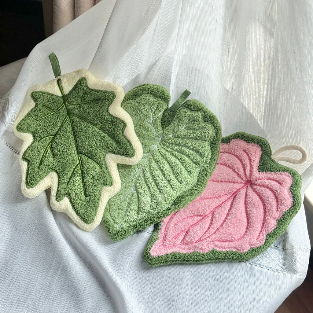 Set of three modern leaf shaped plush hanging hand towels in green, pink, and maple. — view 4