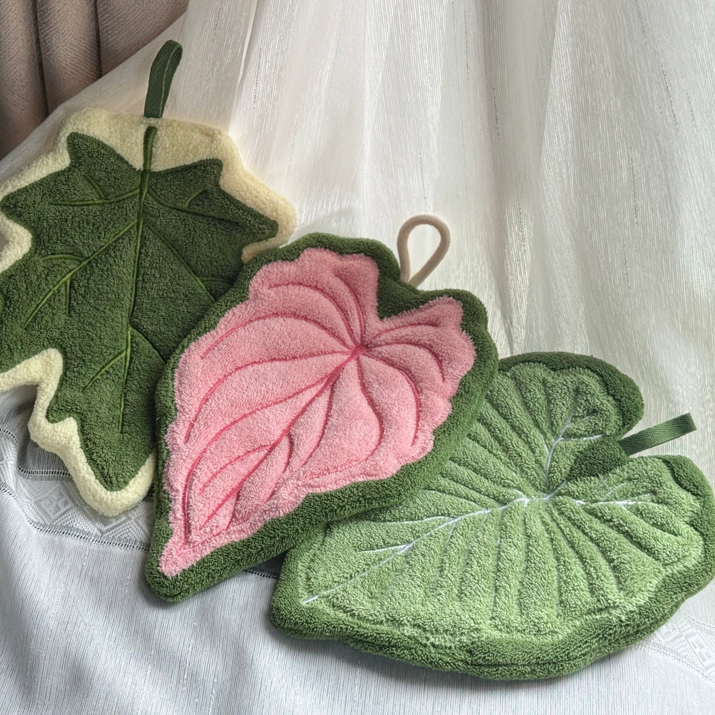 Set of three modern leaf shaped plush hanging hand towels in green, pink, and maple. — view 2
