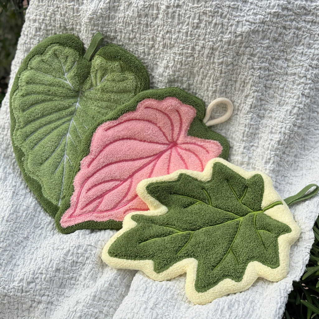 Set of three modern leaf shaped plush hanging hand towels in green, pink, and maple. — view 5