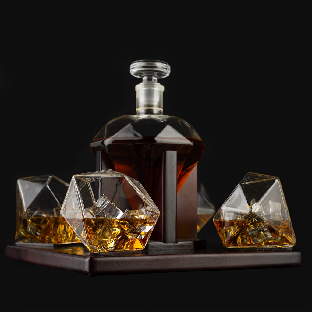 Diamond whiskey decanter set with four tasting glasses resting on an elegant mahogany wooden base — view 2