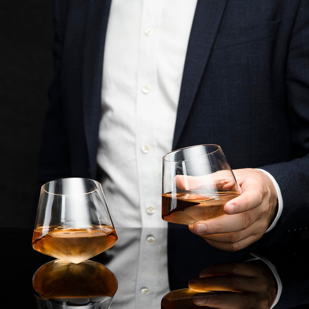 Diamond shaped glass whiskey decanter on a clear base with two matching diamond glasses. — view 3