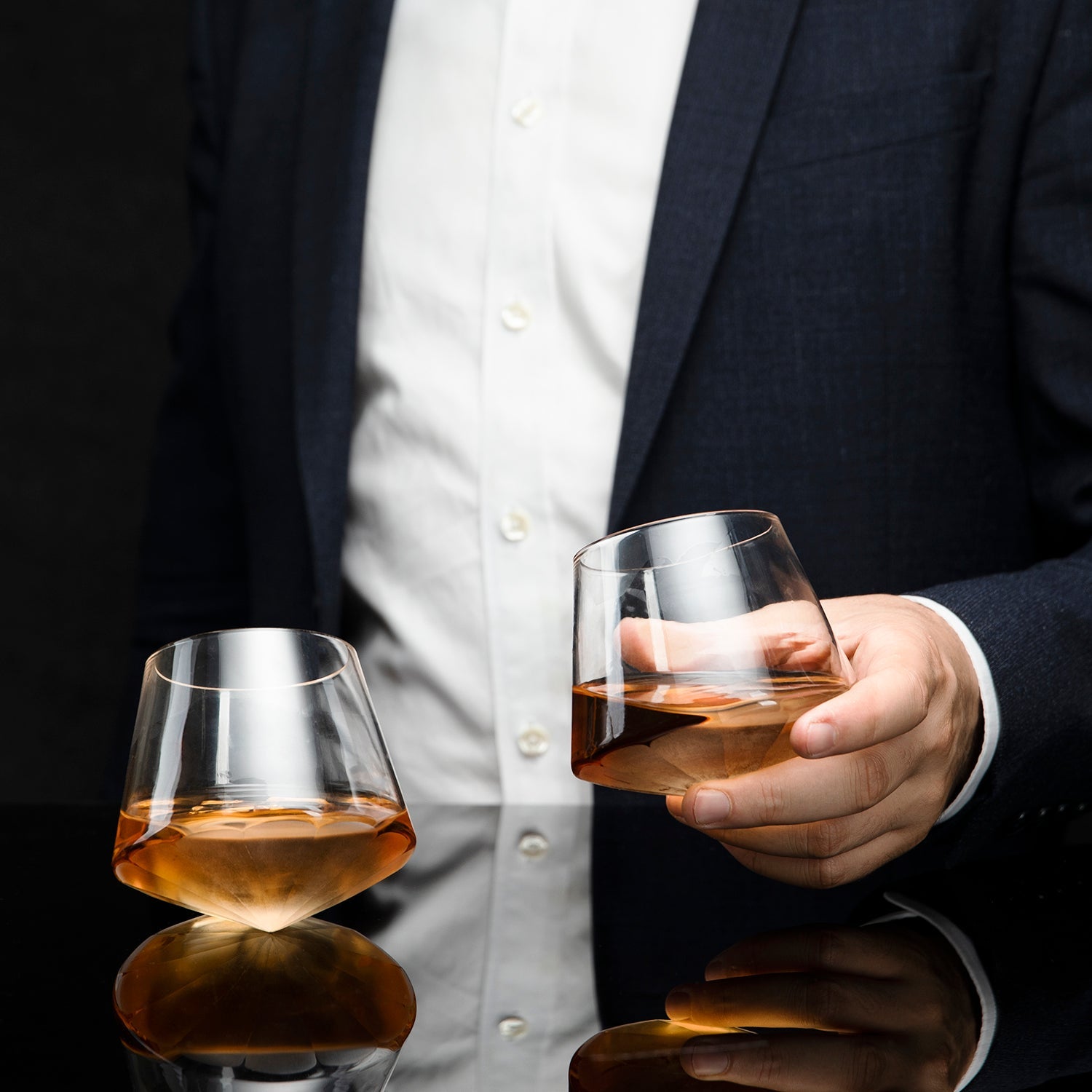 Diamond shaped glass whiskey decanter on a clear base with two matching diamond glasses. — view 3