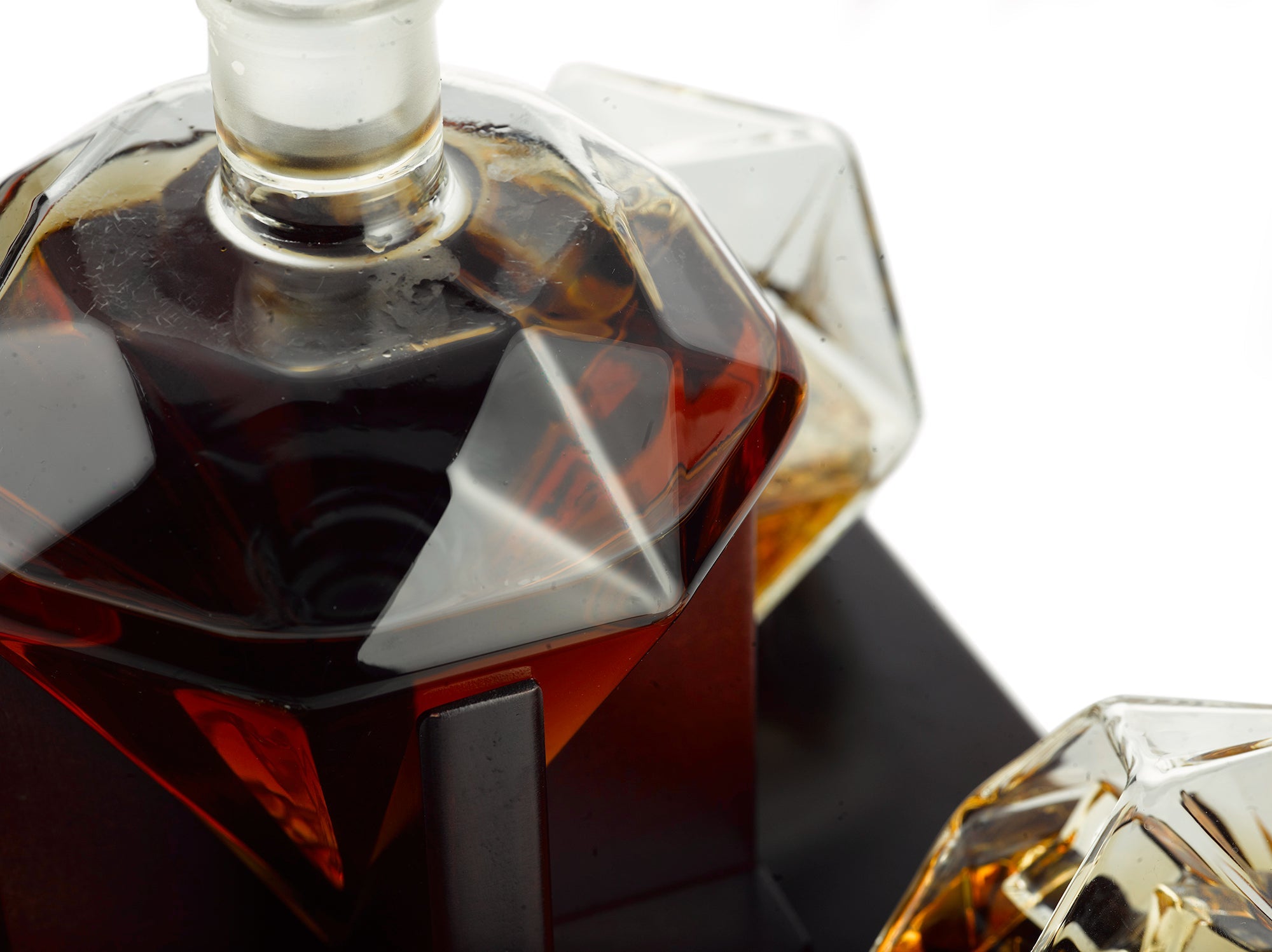 Diamond whiskey decanter set with four tasting glasses resting on an elegant mahogany wooden base — view 4