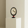 Minimalist retro desktop clock in oval wood with a playful red sphere base