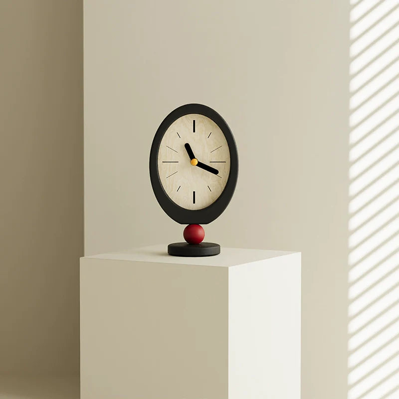 Minimalist retro desktop clock in oval wood with a playful red sphere base