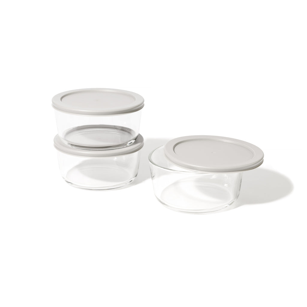 Six round borosilicate glass food storage containers with airtight grey lids for meal prep
