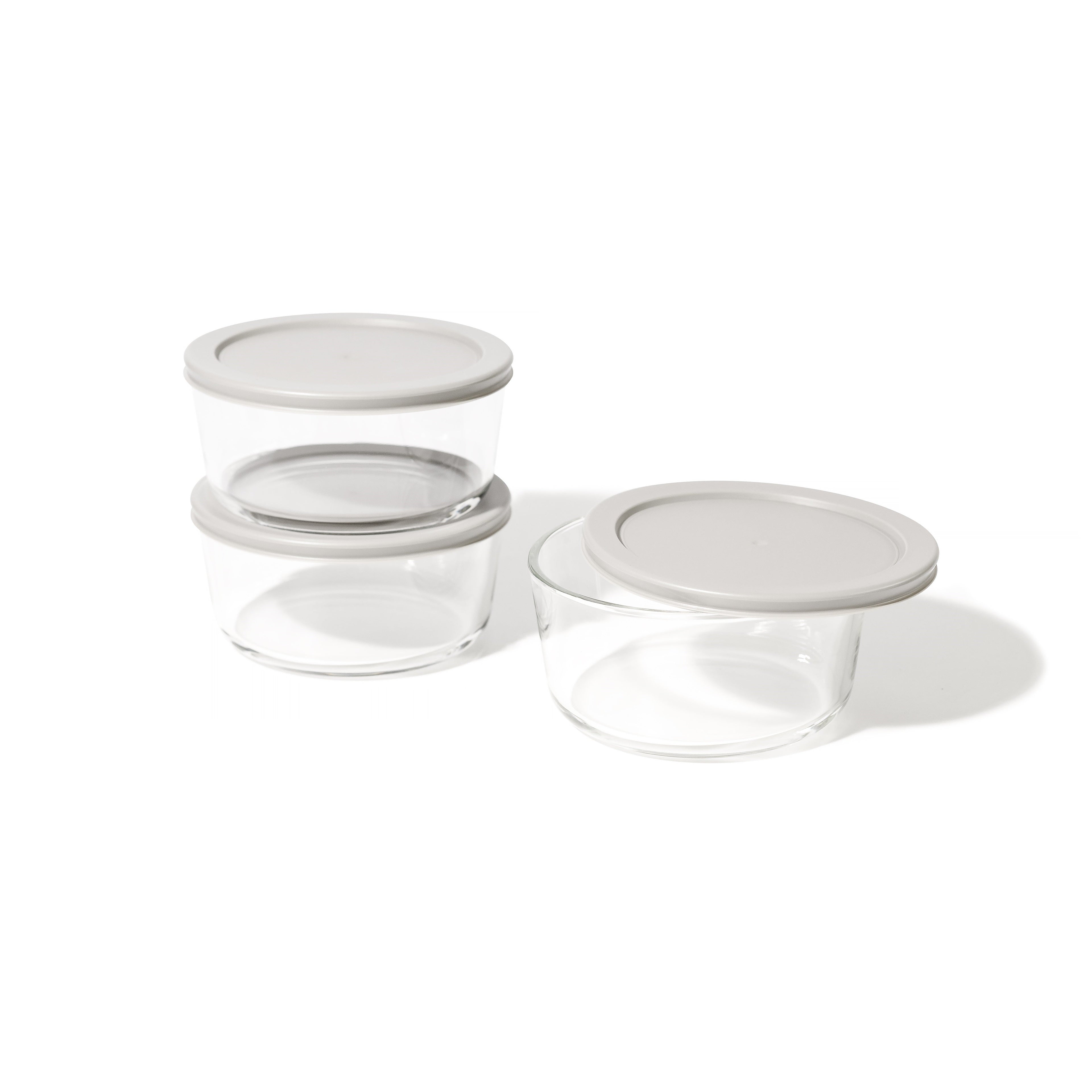 Six round borosilicate glass food storage containers with airtight grey lids for meal prep