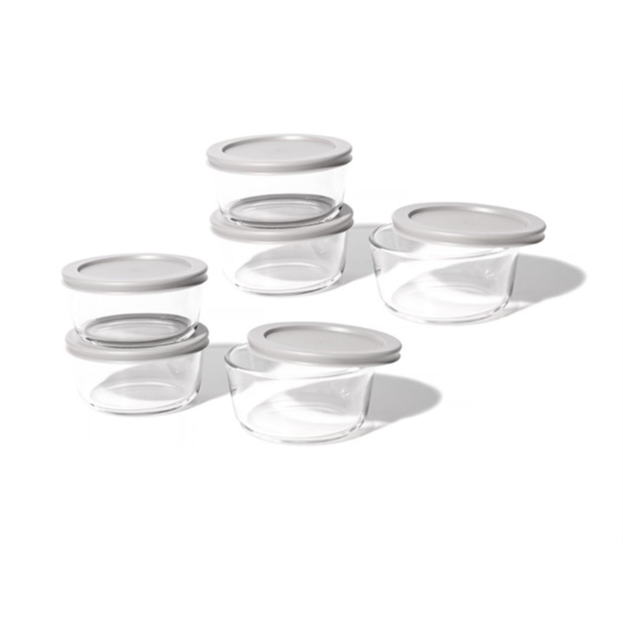 12 piece round glass food storage containers with grey airtight lids on kitchen counter