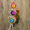 Natural vine twist rope parrot toy made of wood, luffa sponge, and rattan with metal hanger